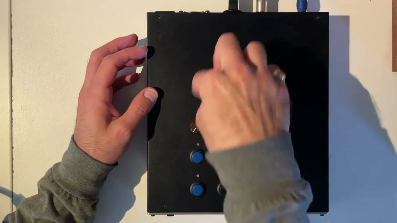 Mid-Air performing on a broad black custom Pikocore arcade box with four knobs and eight buttons