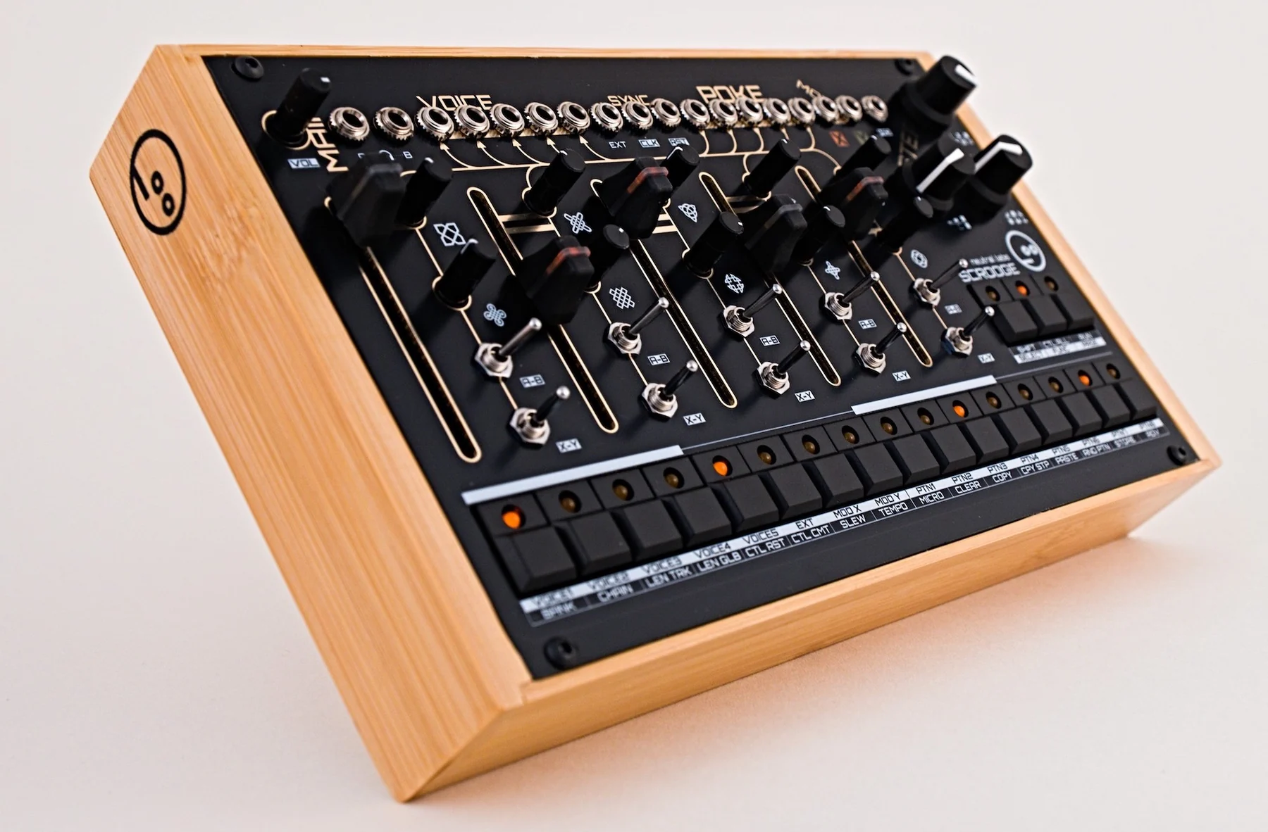 The Neutral Labs Scrooge analog percussion synthesizer in a wooden desktop case