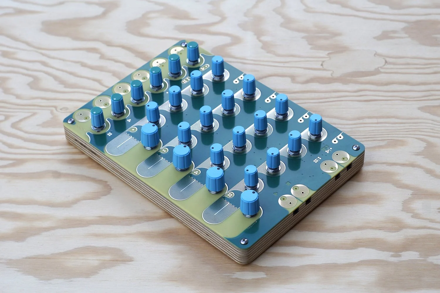 The blue and green Landscape MOON passive drum synthesizer on a wooden surface