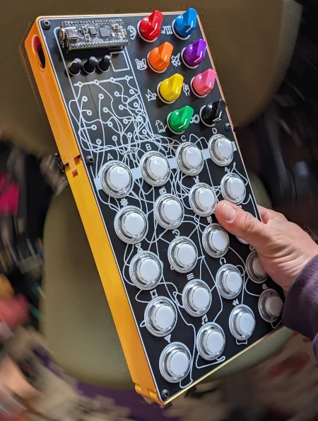 Orange and black 3D-printed Zeptocade enclosure with protected sides and additional audio jacks