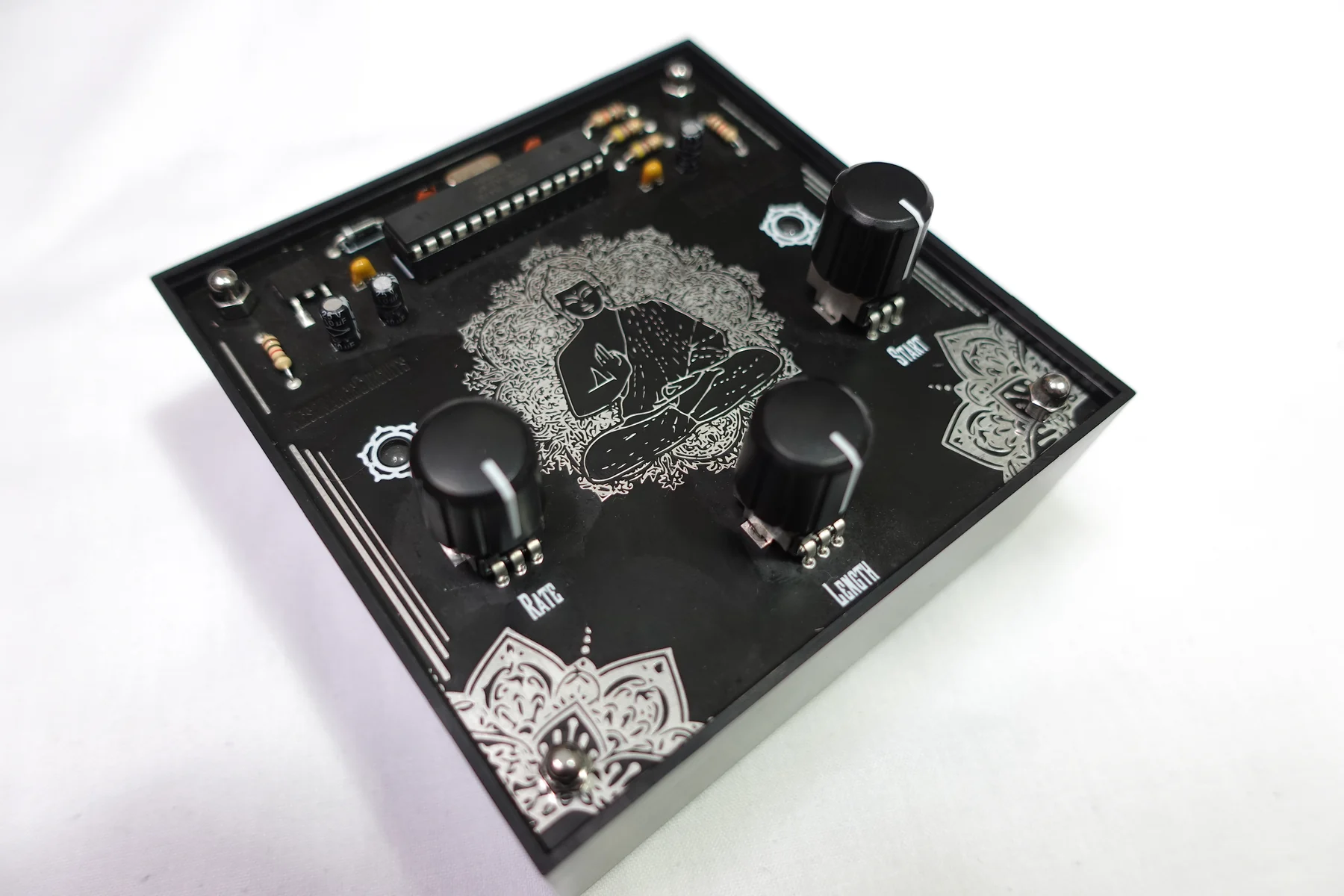 The compact black Mystic Drums loop synthesizer photographed on a white surface