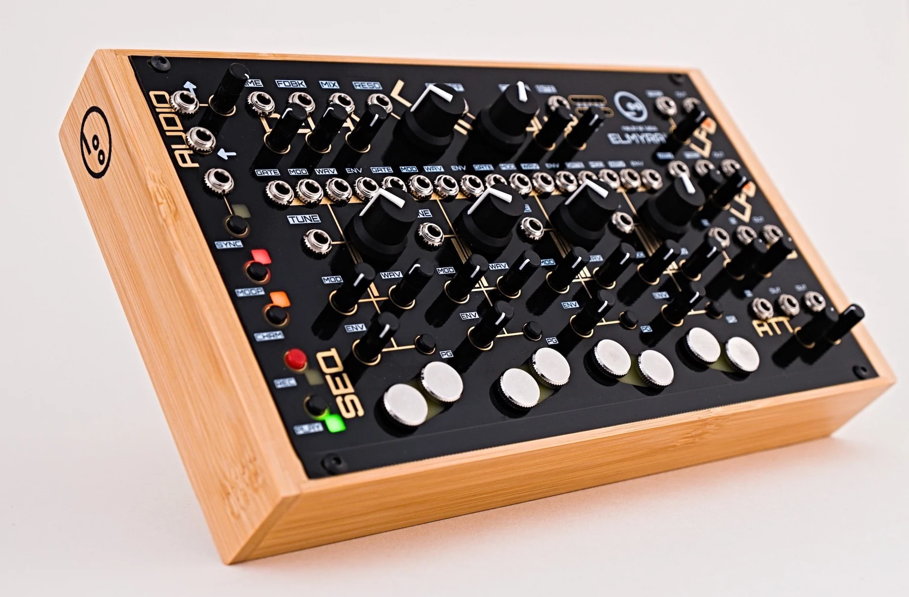 The black Neutral Labs Elmyra 2 drone synthesizer in a bamboo desktop case